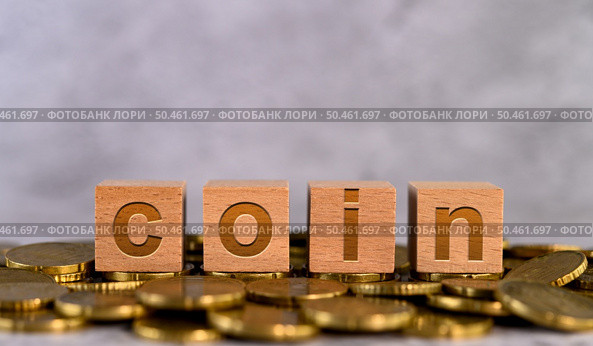 coin word alphabet wooden cube letters placed on a gold coin. Стоковое фото, агентство Ingram Publishing / Фотобанк Лори
