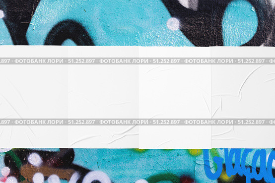 colorful urban wall with four wrinkled glued poster templates. Стоковое фото, фотограф Александра Конопля / Фотобанк Лори