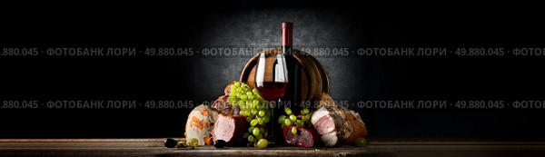 Composition with wine and food on a black background. Стоковое фото, агентство Ingram Publishing / Фотобанк Лори