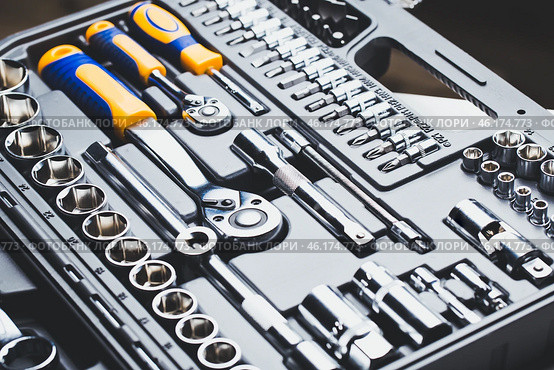 Comprehensive toolset displayed with various sizes of wrenches and sockets arranged neatly in a black case. Стоковое фото, фотограф Сергей Толмачёв / Фотобанк Лори