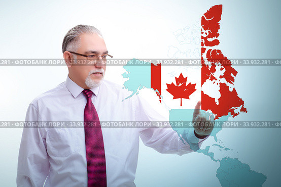 Concept of immigration to Canada with virtual button pressing. Стоковое фото, фотограф Elnur / Фотобанк Лори