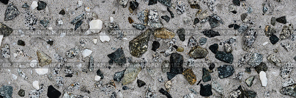Concrete wall texture with pebbles. Decorative rough concrete surface with white, black and gray stones. Wide panoramic texture for background and design. Стоковое фото, фотограф Андрей Степанов / Фотобанк Лори
