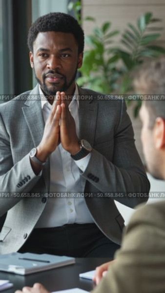 Confident african American male boss work cooperate with diverse team at office briefing, focused biracial businessman head meeting, collaborate discuss business ideas with colleag. Стоковое AI-видео, аниматор Sergey Grishin / Фотобанк Лори