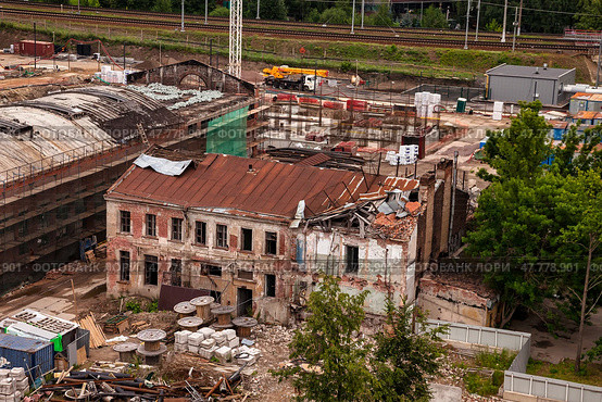 Construction Site With Abandoned Building and Ongoing Development Work in Urban Area. Стоковое фото, фотограф Aleksandr Golubev / Фотобанк Лори
