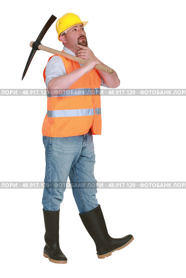 Contemplative labourer holding a pickaxe. Стоковое фото, агентство Ingram Publishing / Фотобанк Лори