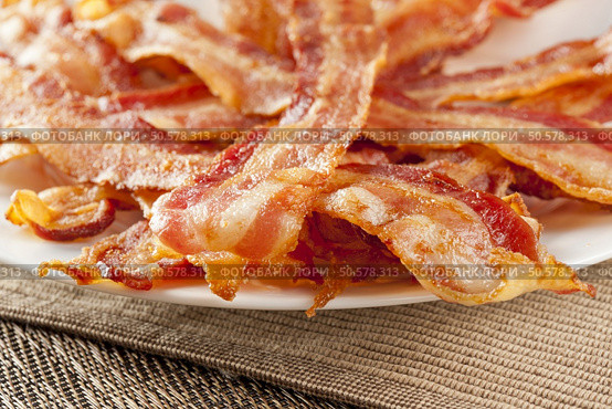 Cooked Greasy Bacon against a back ground. Стоковое фото, агентство Ingram Publishing / Фотобанк Лори