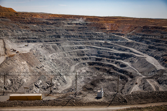 Copper ore open-pit mining (quarry) in steppe. White gravel road. Blue sky background. Стоковое фото, фотограф Alexey Rezvykh / Фотобанк Лори