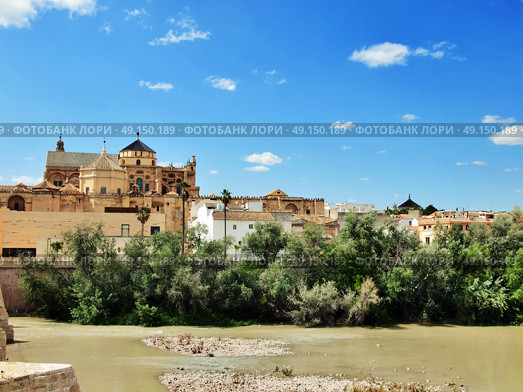 Cordoba, Spain. The Great Mosque (currently Catholic cathedral). UNESCO World Heritage Site. View with famous Roman Bridge and Guadalquivir river. Стоковое фото, агентство Ingram Publishing / Фотобанк Лори