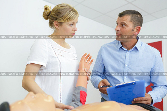 couple are training with dummy. Стоковое фото, агентство Ingram Publishing / Фотобанк Лори