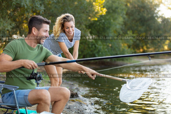 couple fishing at the river with fishing rod and net. Стоковое фото, агентство Ingram Publishing / Фотобанк Лори