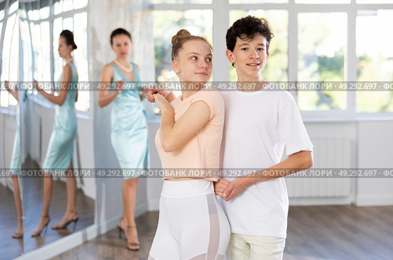Couple of teenage dancers rehearsing ballroom dance with female teacher. Стоковое фото, фотограф Яков Филимонов / Фотобанк Лори