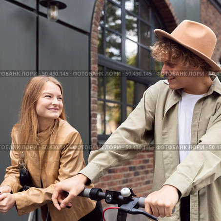 couple outdoors city with electric scooters. Стоковое фото, агентство Ingram Publishing / Фотобанк Лори