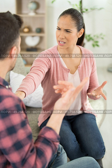 couple sat on sofa having an argument. Стоковое фото, агентство Ingram Publishing / Фотобанк Лори