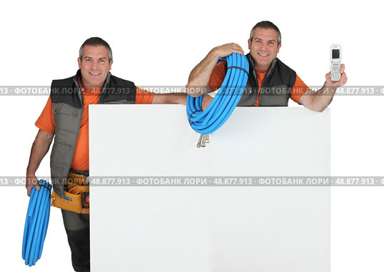 craftsman and his clone phone in hand carrying fluorescent blue hose and. Стоковое фото, агентство Ingram Publishing / Фотобанк Лори