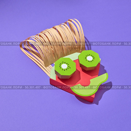Creative composition in the shape of boy’s face handmade from colorful paper from parts of papercraft fruits on a purple background with shadows, copy space. Vegetarian concept.. Papercraft composition from fruits peaces in the shape of face. Стоковое фото, агентство Ingram Publishing / Фотобанк Лори