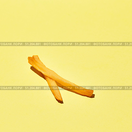 Crispy golden tasty french fries on yellow table in sunlight. Стоковое фото, фотограф Ирина Буракова / Фотобанк Лори