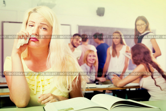 Crying outcast student in college classroom. Стоковое фото, фотограф Яков Филимонов / Фотобанк Лори