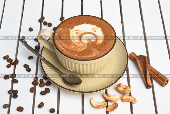 Cup of nut cappuccino with spoon and sugar on wooden white table side view. Стоковое фото, фотограф Татьяна Терехина / Фотобанк Лори