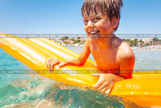 Cute boy floating on inflatable mattress in sea. Стоковое фото, фотограф Сергей Новиков / Фотобанк Лори
