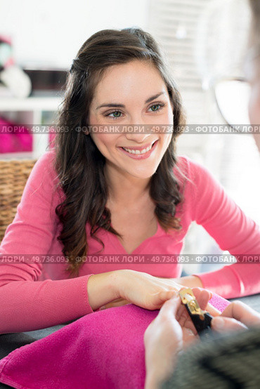 cutting the clients fingernails. Стоковое фото, агентство Ingram Publishing / Фотобанк Лори
