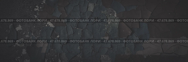 Dark wide panoramic background. Peeling paint on a concrete wall. Faded dark texture of old cracked flaking paint. Weathered rough painted surface with patterns of cracks. Shaded background for design. Стоковое фото, фотограф Андрей Степанов / Фотобанк Лори