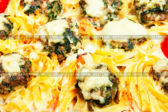 Delicious nests of Fettuccine pasta with meatballs and nettles. Casserole. Close up. Nest of noodle with meatballs. Стоковое фото, агентство Ingram Publishing / Фотобанк Лори