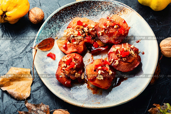 Dessert of caramelized quince with nuts and candied fruits. Eastern sweets. Sweet tasty quince dessert. Стоковое фото, агентство Ingram Publishing / Фотобанк Лори