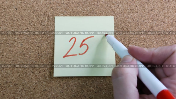 Девушка пишет надпись 25% красным маркером на желтом бумажном стикере, приклеенном к пробковой доске. Женская рука с цветным фломастером. Рукописный текст красивым почерком. Процент скидки, убытка или прибыли. Girl writes the inscription 25% with red marker on yellow paper sticker glued to cork board. Woman hand with colored felt-tip pen. Handwritten text in beautiful handwriting. Percentage of discount, loss or profit. Стоковое видео, видеограф Ирина / Фотобанк Лори