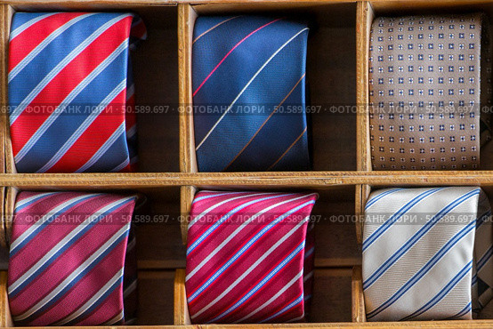 different colors silk tie on display stand. Стоковое фото, агентство Ingram Publishing / Фотобанк Лори