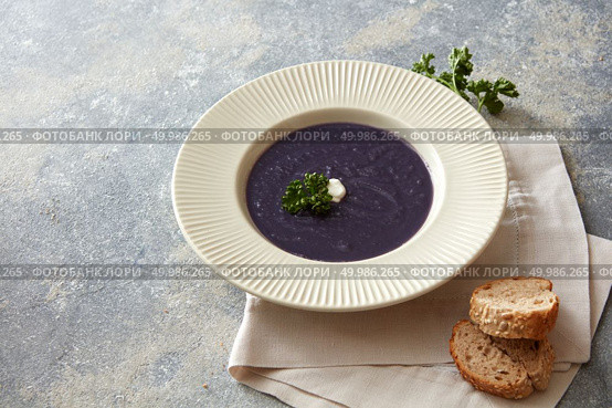 Dinner or lunch concept. Miso soup concept. Delicious vegan soup represented in white plate on table. Some sliced buns near it.. Vegan soup on table. Стоковое фото, агентство Ingram Publishing / Фотобанк Лори