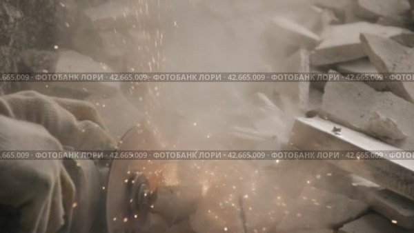 Dismantling of the walls of the destroyed house. Worker with metal-cutting angle grinder. Super slow motion 240 fps. Стоковое видео, видеограф EStarodubov / Фотобанк Лори