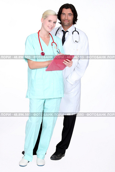 Doctor and nurse stood with patients results. Стоковое фото, агентство Ingram Publishing / Фотобанк Лори