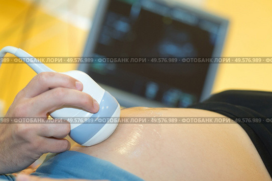 doctor explaining ultrasound scan to pregnant woman in hospital. Стоковое фото, агентство Ingram Publishing / Фотобанк Лори