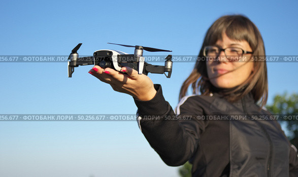 Drone landing on a woman hand palm. Element of design. Стоковое фото, агентство Ingram Publishing / Фотобанк Лори