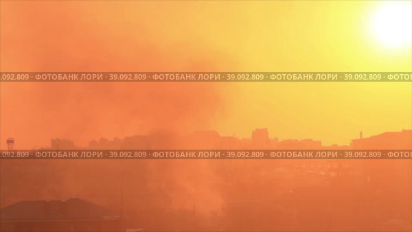 Дым от пожара поднимается над городом в залитое солнечным светом небо. Стоковое видео, видеограф Цыбин Вадим / Фотобанк Лори