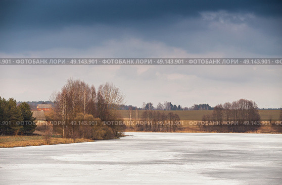 Early spring. Mud season. Lake under ice and snow melting. Cloudy spring day. Spring rural scene. Стоковое фото, агентство Ingram Publishing / Фотобанк Лори