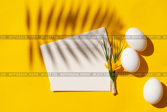 Easter scene with white eggs over illuminating yellow background, copy space, palm sunday easter holiday concept. Easter scene with white eggs. Стоковое фото, агентство Ingram Publishing / Фотобанк Лори