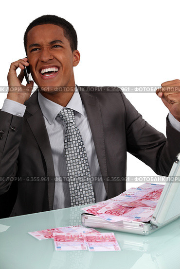 Ecstatic businessman with a briefcase full of money. Стоковое фото, фотограф Phovoir Images / Фотобанк Лори