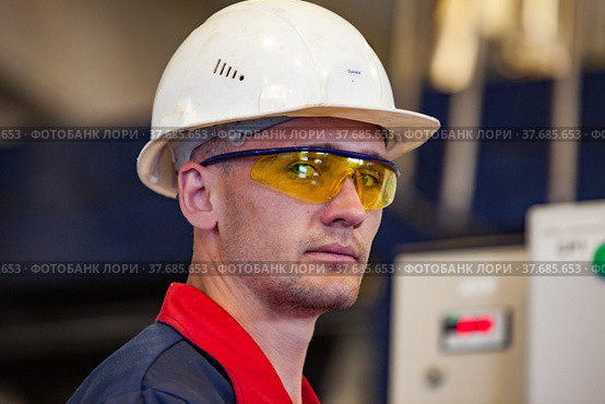 Ekibastuz, Kazakhstan - May 28, 2012. Explosive material production plant for coal quarry mining. Portrait of young technologist engineer. Редакционное фото, фотограф Alexey Rezvykh / Фотобанк Лори