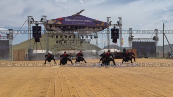 ELANTSY, IRKUTSK REGION, RUSSIA - July 5, 2025: Erdyn Games - festival of nomadic peoples of Eurasia. Video of handsome Buryat youths in national costumes dancing fiery folk dance on open stage. Редакционное видео, видеограф Виктория Катьянова / Фотобанк Лори