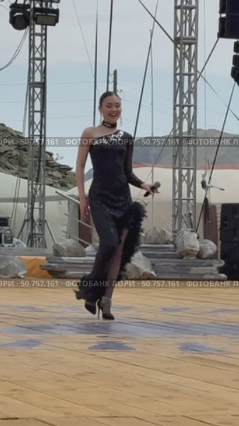 ELANTSY, IRKUTSK REGION, RUSSIA - July 5, 2025: Erdynskie Games – festival of nomadic peoples of Eurasia. Vertical video of beautiful Buryat girl on open stage takes part in beauty contest in summer holidays. Редакционное видео, видеограф Виктория Катьянова / Фотобанк Лори