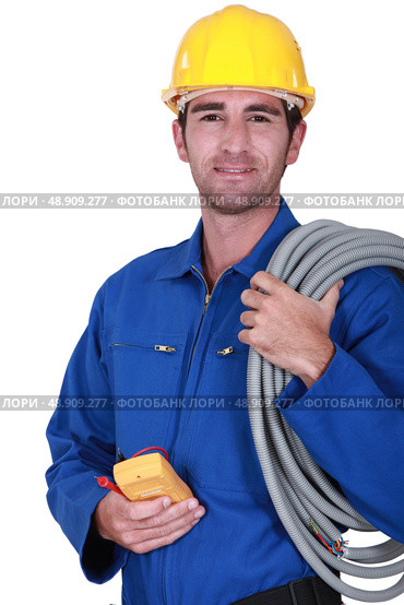 Electrician with voltmeter in hand. Стоковое фото, агентство Ingram Publishing / Фотобанк Лори