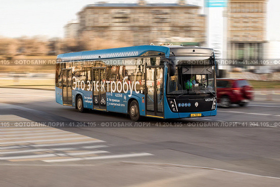Electrobus drive down the street in Moscow, front side view. Electric bus in motion. Редакционное фото, фотограф Константин Григорьев / Фотобанк Лори