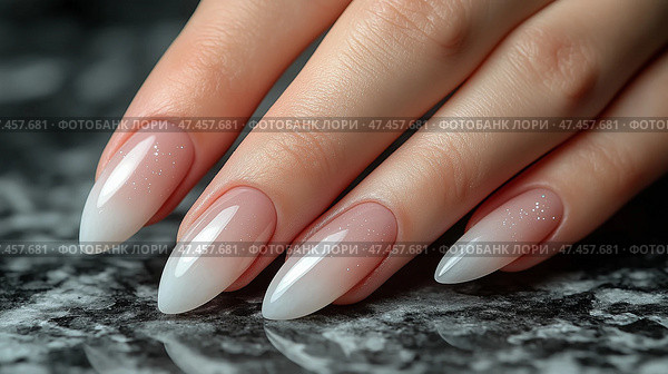 Elegant long stiletto nails with gradient finish on marble surface. На руке - элегантные длинные ногти с мягким градиентом от нюдового до белого. Стоковое AI-изображение, AI-художник Katsiaryna Repich / Фотобанк Лори