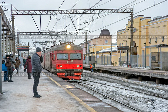 Электричка подъезжает к платформе остановочного пункта Татьянино. Город Гатчина Ленинградской области (2024 год). Редакционное фото, фотограф Румянцева Наталия / Фотобанк Лори