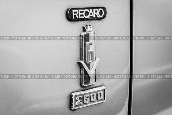 Emblem Recaro (manufacturer of car seats) on the large family car Ford 26M (P7b). Black and white (2014 год). Редакционное фото, фотограф Sergey Kohl / Фотобанк Лори