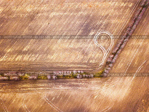 Empty plowed field in early spring. Beginning of the gardening season, top aerial view. Plowed texture. Sunny March rural scene. Belarus, Minsk region. Стоковое фото, агентство Ingram Publishing / Фотобанк Лори