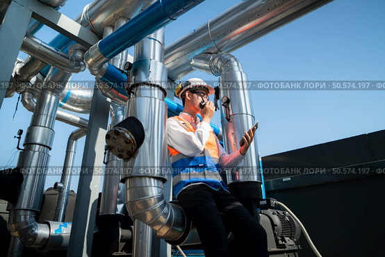 Engineers inspect the completed air conditioning and water systems to continue verifying their functionality. Стоковое фото, агентство Ingram Publishing / Фотобанк Лори