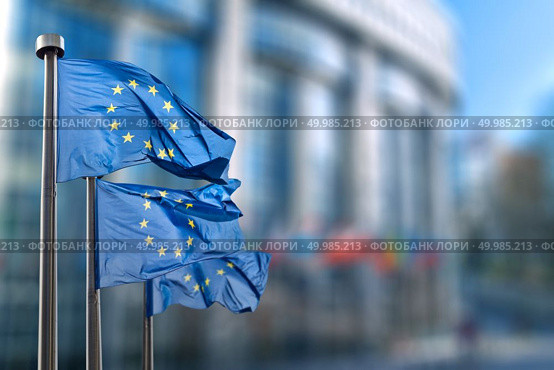 European union flag against parliament in Brussels, Belgium. European union flag. Стоковое фото, агентство Ingram Publishing / Фотобанк Лори