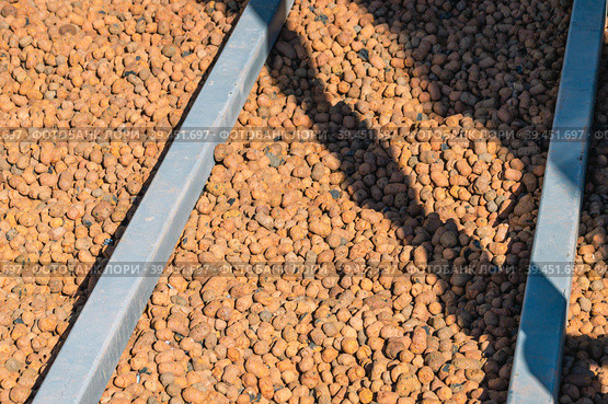 Expanded clay is one of the most environmentally friendly materials, which is made of clay and slate. Floor insulation. Material for insulation in the construction of buildings. Стоковое фото, фотограф Эдуард Белкин / Фотобанк Лори